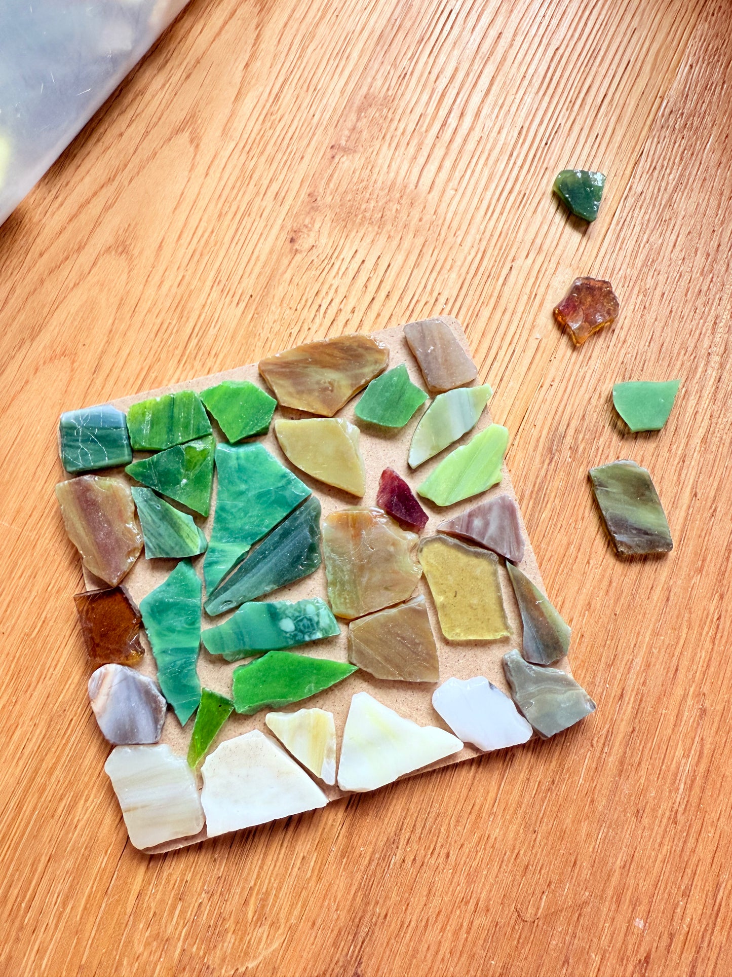 loose tiles on a kraft coaster