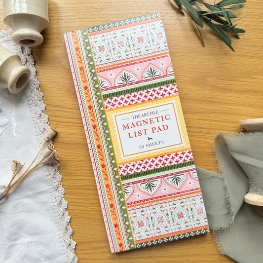 Decorative magnetic list pad with floral patterns on a wooden surface