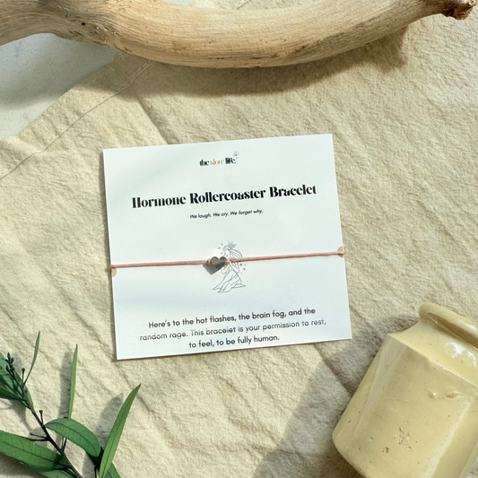 Hormone Rollercoaster Bracelet on a card with text on a beige surface