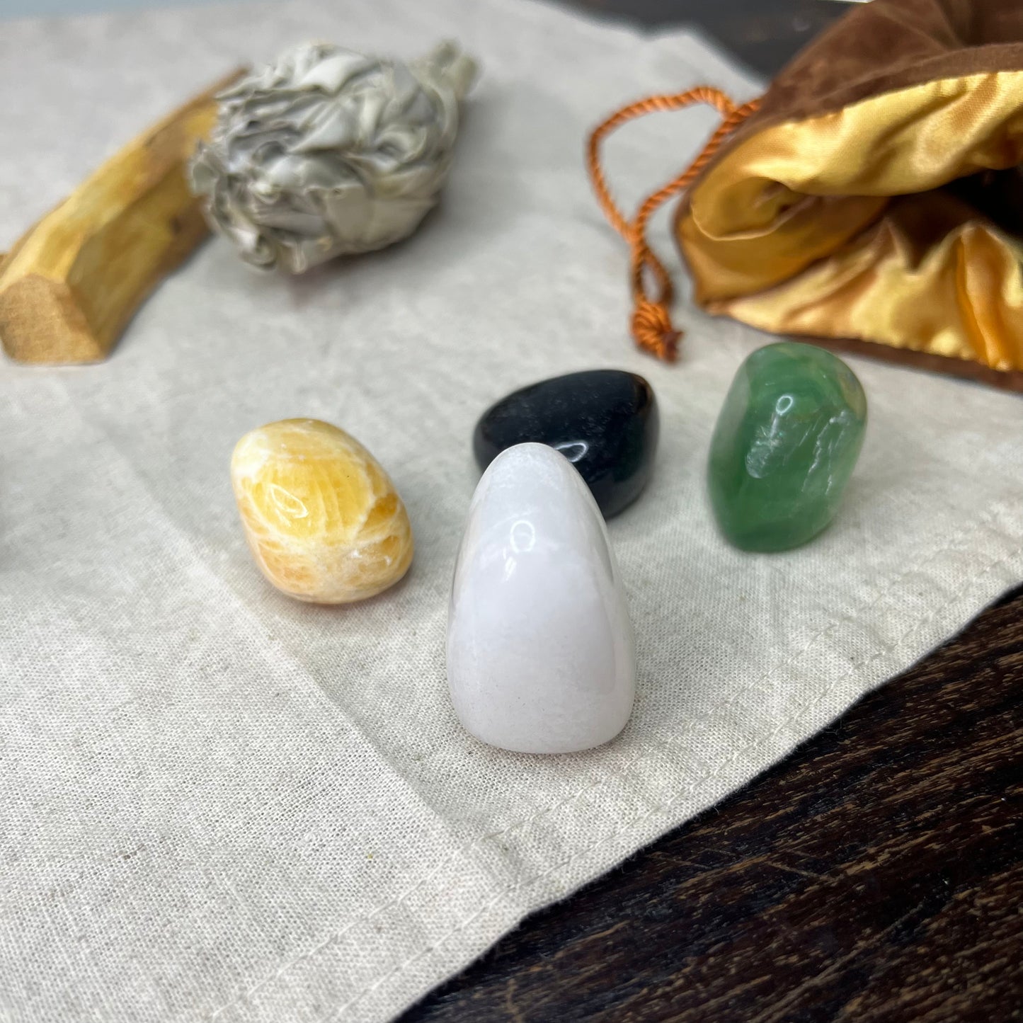 Close-up of the Mindfulness Crystal Set in a luxurious brown velvet bag, showcasing the vibrant colors and unique textures of the four crystals
