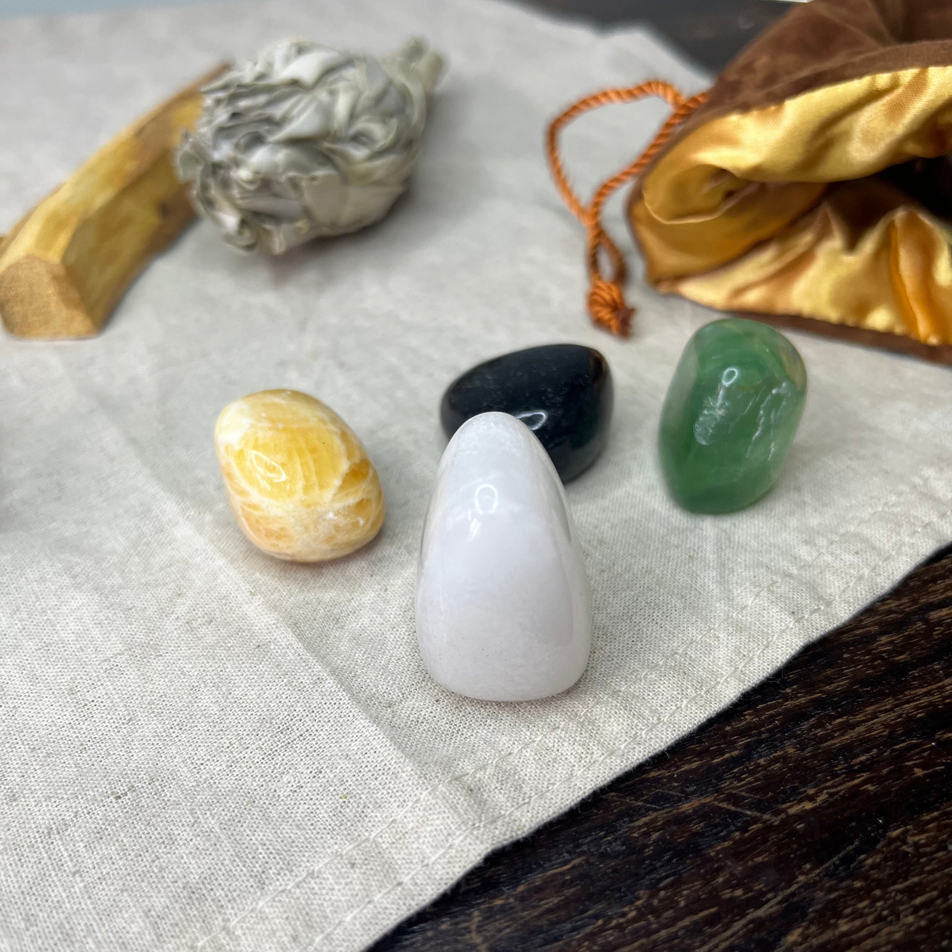 Close-up of the Mindfulness Crystal Set in a luxurious brown velvet bag, showcasing the vibrant colors and unique textures of the four crystals